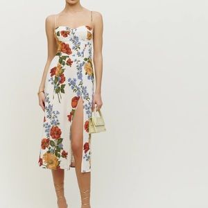 The Juliette is slim fitting throughout with a slit and adjustable straps.